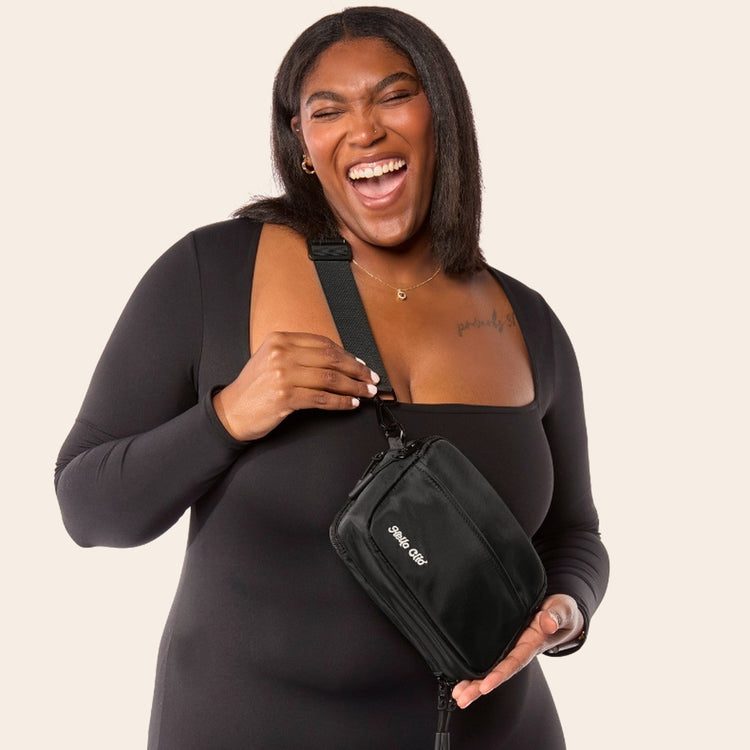Laughing woman wearing the black Hello Clio Original crossbody belt bag